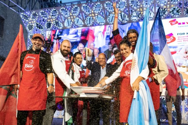 Bia Couscous master chefs celebrate in Italy. Flags of Argentina, France, Morocco. Couscous preparation.