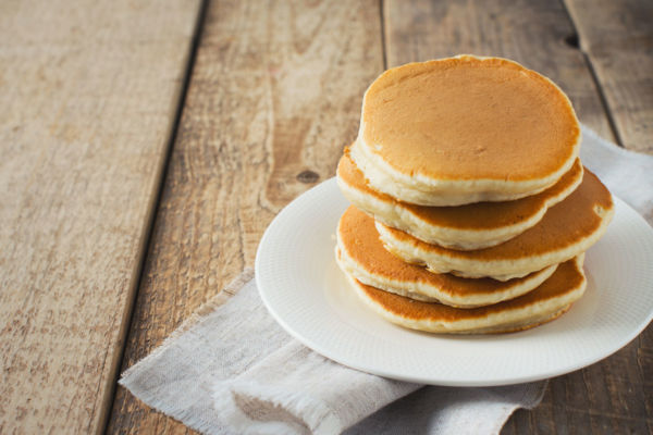 Stack of pancakes on a plate for Pancake Day celebration.