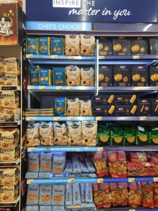 Carrefour aisle with Italian pasta brands: De Cecco, Panzani, Voielle. Chef's Choice pasta selection. Grocery shopping for Italian food.