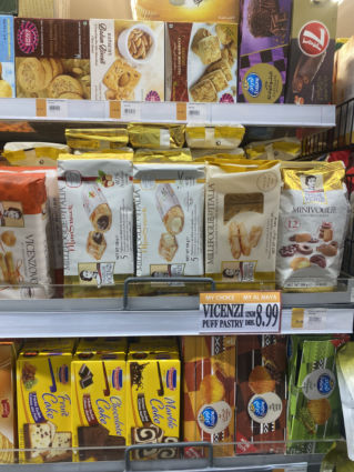 Al Maya Supermarket shelf with Italian food: Vicenzi puff pastry, biscuits, and cakes. Grocery shopping.
